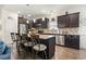 Modern kitchen featuring dark cabinetry, granite countertops, stainless steel appliances and a center island with seating at 230 Palmetto Green Dr., Longs, SC 29568