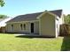 A well-maintained house exterior featuring a green lawn, a concrete patio, and complementary siding and dark roofing at 2429 Westbrook Dr., Conway, SC 29527