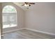 This bedroom has vaulted ceilings, a large window for natural light, and light-colored flooring at 2429 Westbrook Dr., Conway, SC 29527