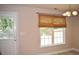 Cozy dining area featuring a window with woven shades and modern chandelier at 2429 Westbrook Dr., Conway, SC 29527