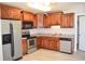 Modern kitchen featuring stainless steel appliances, solid wood cabinetry, and laminate flooring at 2429 Westbrook Dr., Conway, SC 29527
