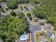 Aerial view showcasing the community's layout, lush greenery, and community pool and surrounding houses at 2654 Wild Game Trail, Myrtle Beach, SC 29588