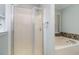 Bathroom featuring a glass-enclosed shower, a soaking tub with stone accents, and a decorative window at 2654 Wild Game Trail, Myrtle Beach, SC 29588