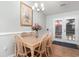 Bright dining area with a wooden table, a stylish chandelier, and sliding glass doors to the patio at 2654 Wild Game Trail, Myrtle Beach, SC 29588