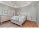 Spacious main bedroom with a tray ceiling, recessed lighting, wood floors, and neutral-toned walls at 2654 Wild Game Trail, Myrtle Beach, SC 29588