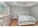 View of the main bedroom with wood floors and neutral-toned walls, showcasing the tray ceiling and recessed lighting at 2654 Wild Game Trail, Myrtle Beach, SC 29588