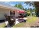 Outdoor patio with wicker furniture and a red umbrella, perfect for outdoor gatherings at 2654 Wild Game Trail, Myrtle Beach, SC 29588