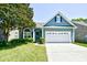 Charming home featuring a manicured lawn, two car garage and mature landscaping at 2705 South Key Largo Circle, Myrtle Beach, SC 29577