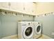 Laundry room featuring a washer and dryer with overhead cabinets for storage at 2705 South Key Largo Circle, Myrtle Beach, SC 29577
