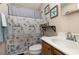 Cozy bathroom with a vanity sink and a shower featuring a nautical themed shower curtain and art at 3012 Sabal Ct., Murrells Inlet, SC 29576
