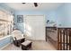 Light blue Bedroom with a dark wood crib, a comfortable rocker, and a window for natural light at 3012 Sabal Ct., Murrells Inlet, SC 29576