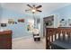 Bedroom with blue walls, ceiling fan, and window with natural light at 3012 Sabal Ct., Murrells Inlet, SC 29576