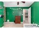 Bedroom featuring green accent wall, ceiling fan, and views into other rooms at 3012 Sabal Ct., Murrells Inlet, SC 29576