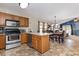 Open kitchen and dining area with stainless steel appliances and a view into the living room at 3012 Sabal Ct., Murrells Inlet, SC 29576
