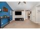 Living room featuring a vaulted ceiling, blue accent wall and access to other rooms at 3012 Sabal Ct., Murrells Inlet, SC 29576