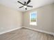 Bright bedroom features light-colored walls, wood-look flooring, and a window with a view at 3415 B And S Rd., Loris, SC 29569