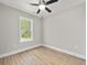 A bright bedroom with wood-look floors and a window providing natural light at 3415 B And S Rd., Loris, SC 29569