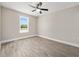 Bright bedroom features light-colored walls, wood-look flooring, and a window with a view at 3415 B And S Rd., Loris, SC 29569
