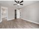 An open bedroom has wood-look floors and white-framed doors to a closet and bathroom at 3415 B And S Rd., Loris, SC 29569