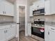 Kitchen with white cabinets, granite countertops, and stainless steel range and microwave, plus pantry at 3415 B And S Rd., Loris, SC 29569