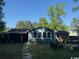 Spacious backyard with stone pathway, patio seating, and mature trees for shade and privacy at 342 Red Fox Rd., Myrtle Beach, SC 29579