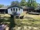 Backyard with green lawn, lounge chairs and a building in the background at 342 Red Fox Rd., Myrtle Beach, SC 29579