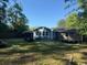 Over-sized backyard with a blue house, lots of green space and mature trees at 342 Red Fox Rd., Myrtle Beach, SC 29579