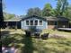 Backyard showing furniture, trees and a combination of lawn and paving stone at 342 Red Fox Rd., Myrtle Beach, SC 29579