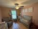 Bedroom with a gray crib and rocking chair, complemented by neutral walls, creating a cozy space at 342 Red Fox Rd., Myrtle Beach, SC 29579