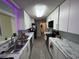 Galley kitchen featuring white cabinets, gray subway tile backsplash, marble countertops, and stainless steel appliances at 342 Red Fox Rd., Myrtle Beach, SC 29579