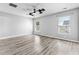 This is a spacious bedroom with light gray walls, ceiling fan, two windows, and gray wood-look flooring at 356 Whipple Run Loop, Myrtle Beach, SC 29588