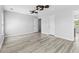 This is a spacious bedroom with light gray walls, ceiling fan, two doors, and gray wood-look flooring at 356 Whipple Run Loop, Myrtle Beach, SC 29588