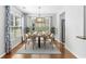 Elegant dining area with a modern chandelier, hardwood floors, and stylish curtains at 356 Whipple Run Loop, Myrtle Beach, SC 29588