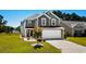 Charming two-story home with a two-car garage and manicured lawn in a suburban neighborhood at 356 Whipple Run Loop, Myrtle Beach, SC 29588
