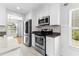 Updated kitchen boasts stainless steel appliances, white cabinets, and a view into the adjacent room at 356 Whipple Run Loop, Myrtle Beach, SC 29588