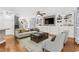 Cozy living room featuring hardwood floors, a ceiling fan, and built-in shelving at 356 Whipple Run Loop, Myrtle Beach, SC 29588