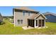 Charming rear exterior featuring a screened porch, green siding, and a well-maintained lawn at 356 Whipple Run Loop, Myrtle Beach, SC 29588