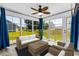 Relaxing sunroom surrounded by large windows, wicker furniture, and plenty of natural light at 356 Whipple Run Loop, Myrtle Beach, SC 29588