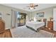 Bright bedroom boasts a ceiling fan, closet, and large sliding glass doors to deck at 4006 Fairway Lakes Dr. # 4006, Myrtle Beach, SC 29577