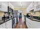Bright galley kitchen features stainless appliances, white cabinets, and sleek countertops at 4006 Fairway Lakes Dr. # 4006, Myrtle Beach, SC 29577