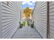 Exterior walkway showcasing a grey wood fence and garden with vibrant green plants at 4006 Fairway Lakes Dr. # 4006, Myrtle Beach, SC 29577