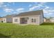 Grassy backyard with a covered patio, ideal for outdoor living at 419 Lifestyle Court, Surfside Beach, SC 29575