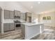 Modern kitchen with stainless steel appliances and an island overlooking the dining area at 419 Lifestyle Court, Surfside Beach, SC 29575