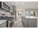 Open kitchen showcasing stainless steel appliances and gray cabinets at 419 Lifestyle Court, Surfside Beach, SC 29575