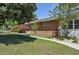 Brick home featuring manicured landscaping, a lush lawn, and a charming walkway at 4196 E Highway 319, Conway, SC 29526