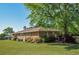 Well-maintained brick home exterior with manicured lawn, mature trees and shrubs, providing a serene view at 4196 E Highway 319, Conway, SC 29526