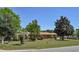 Charming brick home featuring a lush, well-manicured front yard with mature trees and landscaping at 4196 E Highway 319, Conway, SC 29526
