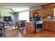 Open-concept kitchen leading to living area, showcasing stainless appliances and wood floors at 4196 E Highway 319, Conway, SC 29526