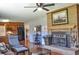 Living room with brick fireplace, hardwood floors, and open layout to the kitchen at 4196 E Highway 319, Conway, SC 29526