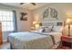 Cozy main bedroom featuring plush bedding, decorative wall art and natural light from the window at 4196 E Highway 319, Conway, SC 29526
